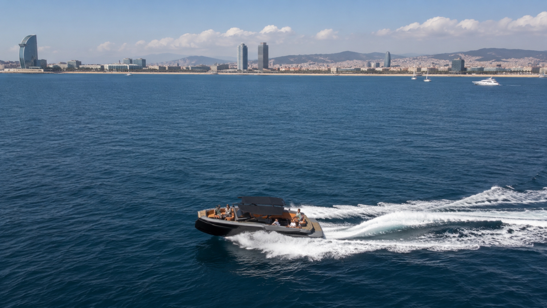 KAY private sport yacht cruising with the Barcelona skyline in the background